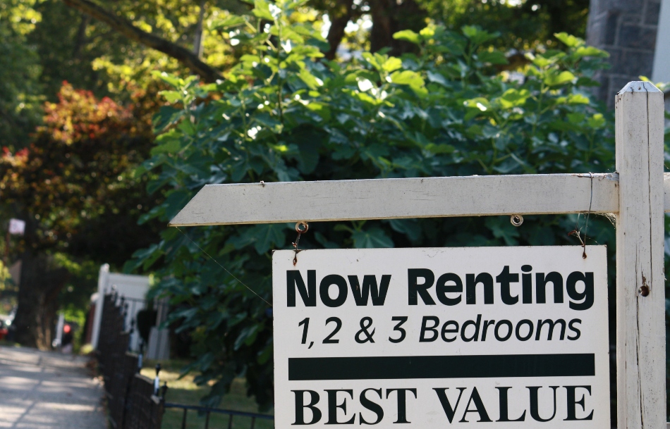 sign in front of a rental that reads "Now Renting 1, 2 & 3 Bedrooms Best Value