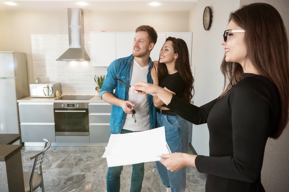 image of property manager showing a couple their new apartment